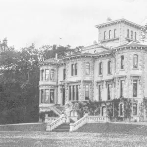 Old photograph of the house taken from an angle. Another large mansion visible behind Clevedon