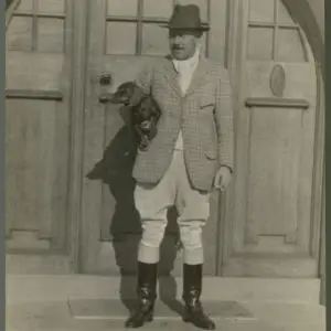Black and white photograph of Major Harold Stanley Cayzer holding a dog
