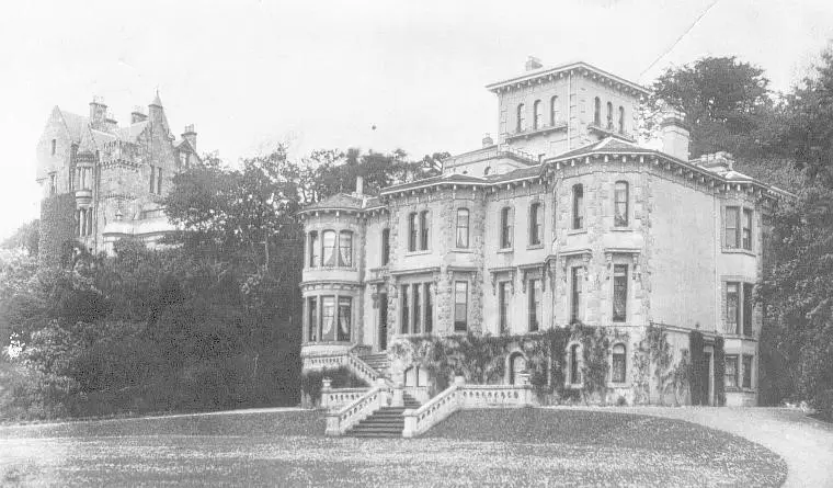 Old photograph of the house taken from an angle. Another large mansion visible behind Clevedon